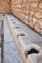 Ancient Public Toilets In Ephesus Archaeological Site. Turkish Landmark
