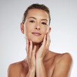 Face, beauty and skincare with mature woman hands touching her skin in a studio on a gray background. Product, antiaging and cosmetics with a female posing for health, wellness or natural care