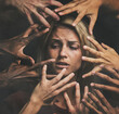 © Clement Coetzee/peopleimages.com - Many hands, face and abuse with a woman victim feeling fear, alone or crying in studio on a dark background. Sad, pain and violence with a scared female suffering with stress or social anxiety