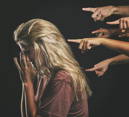 Wall Mural - People judge depressed young woman, fear social anxiety and mental health burnout with fingers point at sad girl. Stressed person frustrated, emotional headache from failure and social bullying