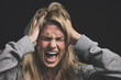 © C Coetzee/peopleimages.com - Screaming woman, mental health and depression headache from bipolar anxiety, stress and fear on black background. Angry, psychology and crazy person shout, scary drugs problem and depressed identity