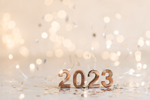 Holiday Background Happy New Year 2023. Numbers Of Year 2023 Made By Gold Candles On Bokeh Festive Sparkling Background. Celebrating New Year Holiday, Close-up. Space For Text