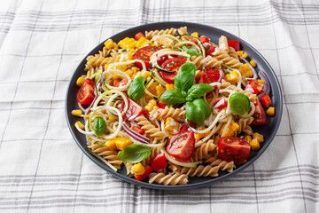 Wall Mural - healthy pasta salad with zucchini sweet corn tomato and basil, vegetarian lunch