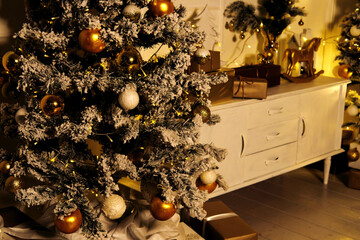 Wall Mural - Christmas and New Year interior room with a high Christmas tree decorated with golden balls and a garland.