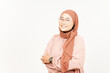 © Sino Images Studio - Smiling Folding hands and looking at camera of Beautiful Asian Woman Wearing Hijab