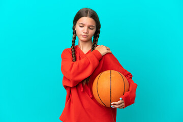 Poster - Little caucasian girl playing basketball isolated on blue background suffering from pain in shoulder for having made an effort