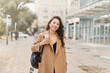 © olga pink - Lifestyle portrait pretty Asian kazakh woman with brilliant smile on street