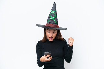 Young caucasian woman costume as witch isolated on white background surprised and sending a message