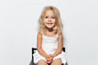 © Lalandrew - Studio portrait of smiling child girl with blonde hair on white background.