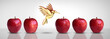 © freshidea - Metaphor for new idea and creative thinking as a symbol of innovation and inspiration concept as a group of red apples as one different apple transforming into a fruit sculpture of a bird in flight.