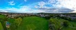 Panoramic view of the green football field and blue cloudy sky. Harrow, Greater London, England, UK.