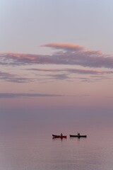 Vertical shot of the kayakers on the beautiful Lake Superior during the sunset