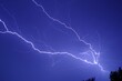 Breathtaking view of flash of lightning in bright blue sky