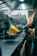 vertical shot of professional cook while preparing the food