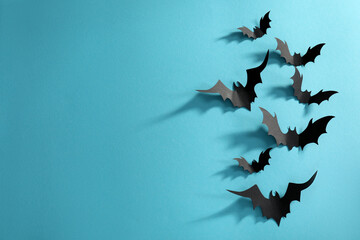 Wall Mural - Flat lay composition paper bats on light blue background, space for text. Halloween decor