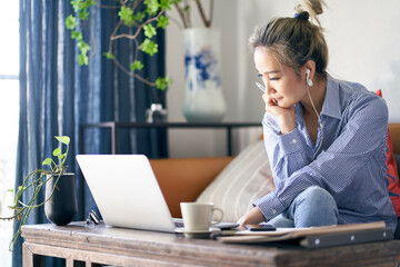 Wall Mural - mature asian woman working from home using notebook computer