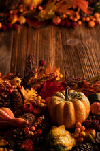 Autumn Composition On A Rustic Wooden Background. Decorative Pumpkins, Various Leaves, Pine Cones, Nuts. Orange, Yellow, Red  And Brown Aesthetics. 