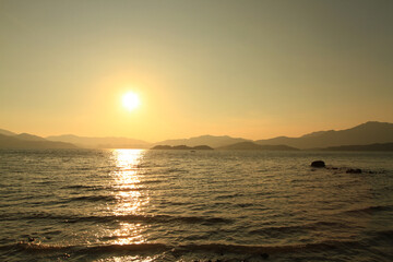 Wall Mural - a Sunset on a rocky beach in Hong Kong.