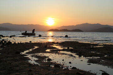 Wall Mural - a Sunset on a rocky beach in Hong Kong.