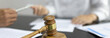 © Puwasit Inyavileart - Attorney or lawyer handing client a pen to sign a business contract, Signing the contract according to the terms and conditions, scales of justice, law hammer, Concept of litigation and legal services