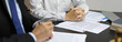 © Puwasit Inyavileart - Lawyers or judges sign documents in accordance with legal and fair terms of agreement, Legal Ethics and Integrity, scales of justice, law hammer, Litigation and legal services.