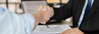 © Puwasit Inyavileart - Businessman shaking hands with a lawyer or judge After signing the contract and the agreement is complete, Approval of an agreement between business and law, End of the legal case.