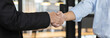 © Puwasit Inyavileart - Businessman shaking hands with a lawyer or judge After signing the contract and the agreement is complete, Approval of an agreement between business and law, End of the legal case.