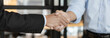 © Puwasit Inyavileart - Businessman shaking hands with a lawyer or judge After signing the contract and the agreement is complete, Approval of an agreement between business and law, End of the legal case.
