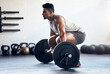 © Tashriq P/peopleimages.com - Workout, weightlifting and man doing deadlift training with strength, weights and motivation in fitness gym. Bodybuilder, sport and strong athlete doing power exercise with a dumbbell at health club