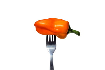 Wall Mural - A whole yellow bell pepper on a fork.