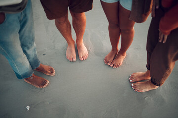 Wall Mural - Friends, feet and beach in water, sand and travel summer vacation with diversity, men and women. People group relax on tropical sea holiday with wet toes together while traveling, friendship and trip