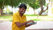 © Govind - Picture of handsome man in casual t-shirt holding silver notebook and chatting or working.