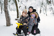 © Studio Peace - Father and children: son and daughter sledding in a snowy forest.