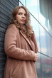 © Stanislav - Street photo session of a girl with blond long hair in a beige coat. Photo shoot in the big city.