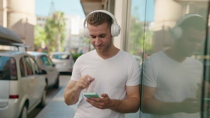 Sticker - Young caucasian man listening to music and dancing at street