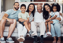 Big Family Portrait On Sofa, Home Living Room Together In Mexico And Happy Afro Latino Girl Sitting On Mom Lap. Senior Grandparents Love Young Children, Proud Father Smile And Generations Happiness