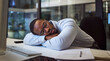 Black man in business, tired and sleeping on night office desk after programming computer code, database seo or cybersecurity. Burnout, exhausted and sleepy worker with documents deadline in Nigeria