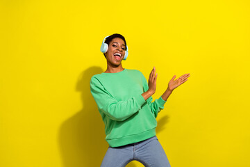 Wall Mural - Photo of beautiful sweet short hair person dressed casual pullover dancing listening music isolated yellow color background