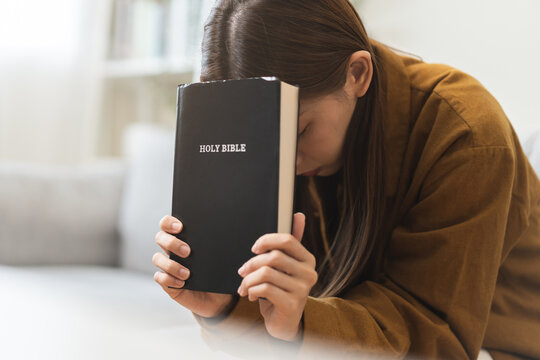 Religion and believe, faith christian woman holding holy bible book in hand, peace and hope of humble. Pray, prayer person meditating, praying to request God, jesus asking for help, spiritual concept.