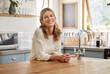 © Nina Lawrenson/peopleimages.com - Retirement woman and relax in kitchen portrait with attractive and happy smile resting in house. Senior, elderly and positive lady in Canada home enjoying leisure break and pension lifestyle.