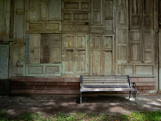 Rest area with old vintage style chair and decoration wall with pieces of old wood windows retro style.