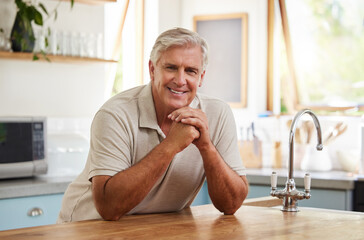 Canvas Print - Smile, portrait and senior man in kitchen home alone in retirement. Relax, retired and elderly happy male from Canada in house, thinking and happiness with lifestyle, confidence and positive mindset.