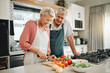 © Kay Abrahams/peopleimages.com - Senior couple, healthy food and cooking lunch together in Australia kitchen at home. Happy woman, hungry man and retirement people cut vegetables for nutrition diet, wellness and vegan dinner meal
