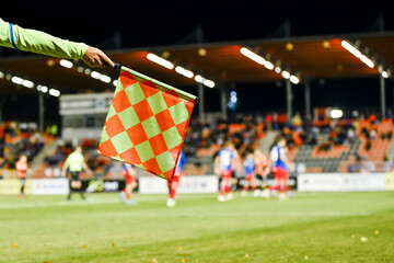 Wall Mural - Soccer touchline referee's flag with the flag during match at the football stadium.