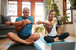 © N Lawrenson/peopleimages.com - Couple, stretching and yoga with laptop to watch online video tutorial. Senior man and woman warm up with pilates and exercise on virtual class on the floor with peace, fitness and training