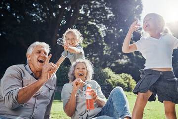 grandparents, bubbles and children play in park happy together for fun, joy and outdoor happiness. r