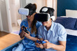 © tai - excited married couple play vr glasses. cheerful wife and husband enjoy virtual reality together using controller. boyfriend and girlfriend using future modern gaming headset technology for hobby