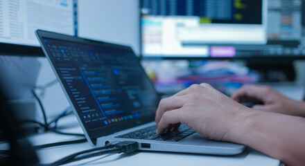 close up specialist programmer man hand type configuration on keyboard at laptop for check software for fix bug and defect of system in data center room , engineering and technology