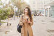 © olga pink - Lifestyle portrait pretty Asian kazakh woman with phone on street
