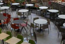 Empty Tables And Comfortable Seating At A Food Court In A Shopping Mall.